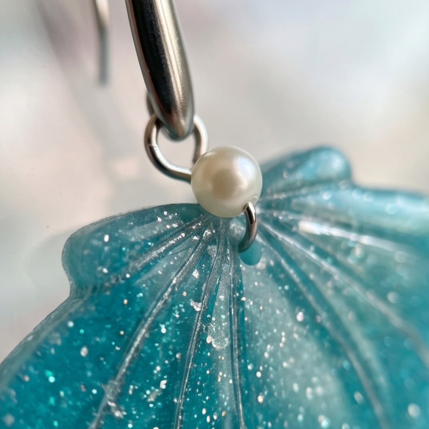 Pormenor artesanal de concha em argila polimérica com acabamento em resina UV.